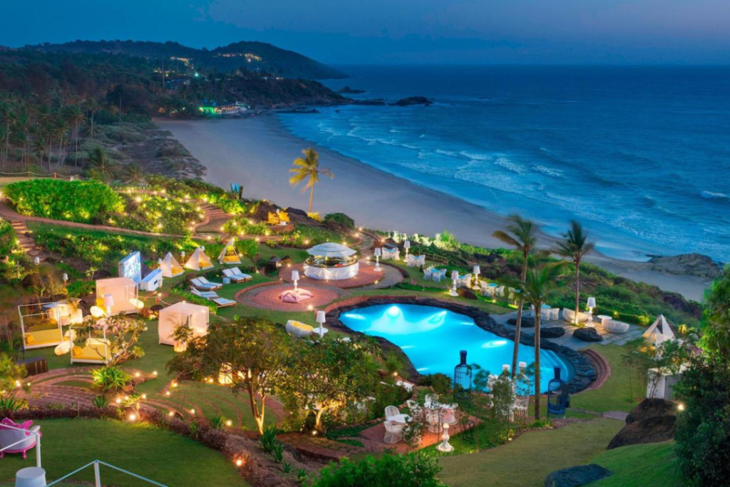 Scenic view of Goa beach with palm trees, golden sand, and blue ocean – perfect destination for relaxation and adventure on a Goa Tour