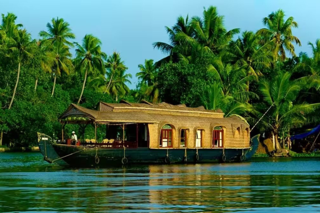 Scenic view of Kerala backwaters with a traditional houseboat surrounded by lush greenery during a serene tour in Kerala, India.